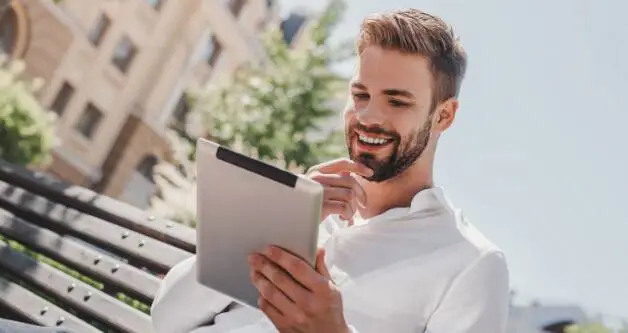Man-Looking-at-Tablet