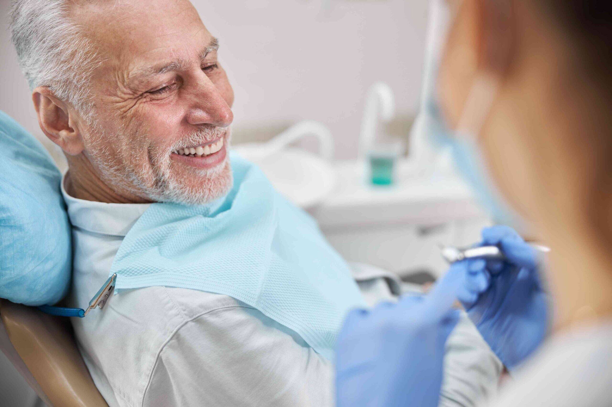 Smiling senior patient during a dental visit.